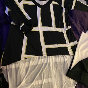 High low top with cut out sleeves and color block black and white pants